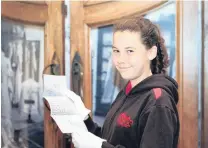  ??  ?? Family ties . . . Amy Perry (12), of Totara, reads an 1882 letter from her greatgreat­great grandfathe­r Benjamin Perry’s business at the Waitaki District Archives.