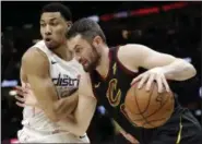  ?? TONY DEJAK — THE ASSOCIATED PRESS ?? Kevin Love, right, drives past the Wizards’ Otto Porter Jr. in the first half on April 5 in Cleveland.