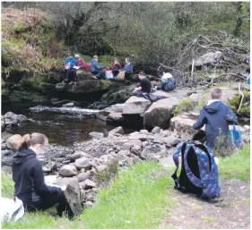  ??  ?? Pupils enjoy their lunch break in an idyllic setting.