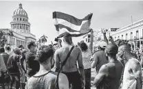  ?? Tribune News Service file photo ?? Cubans protest the government outside Havana’s Capitol in July. More than 1,000 demonstrat­ors were detained.