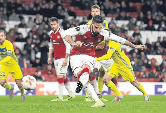  ??  ?? Olivier Giroud fires in from the spot during Arsenal’s 6-0 rout of BATE Borisov last night in front of a record-low Emirates Stadium crowd.