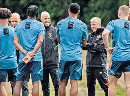  ?? ?? Fresh start: Manchester United’s new manager Erik ten Hag (fourth from the left) speaks to players on the first day of pre-season training