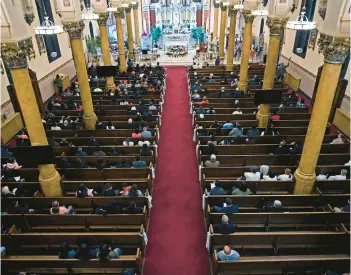  ?? KENNETH K. LAM/STAFF ?? Hundreds attended a bilingual prayer service April 8 at Sacred Heart of Jesus Christ followed by a candleligh­t prayer walk for the six men who died in the Key Bridge collapse.