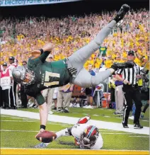 ?? ROD AYDELOTTE/ WACO TRIBUNE-HERALD VIA THE ASSOCIATED PRESS ?? Baylor’s Seth Russell scores in a 49-7 win over Kansas on Saturday in Waco, Texas. The Big 12 Conference on Tuesday announced it is sticking with 10 teams, but that may prove costly for the struggling league.