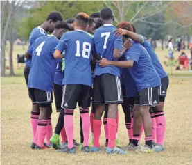  ?? MONICA RHOR ?? The reVision FC players, most of whom came as refugees from a mix of African countries, huddle on a Houston soccer field before a big game.