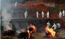  ?? Photograph: Navesh Chitrakar/Reuters ?? Workers wearing personal protective equipment enlarge a crematoriu­m in Kathmandu, Nepal, on 5 May as the number of people dying from Covid rises.