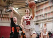  ?? ?? Kitty White (30) of Redwood goes for a layup against April Zelinski (12) of Washington in a NCS D-II first round game at Redwood High School in Larkspur on Wednesday