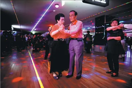  ?? KIM HONG-JI / REUTERS ?? Han Min-ja and Yang Won-ju dance at the New Hyundai Core colatec in Seoul, South Korea, on April 10. The dance halls are increasing­ly providing a lifeline for the country’s seniors.