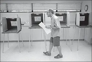  ?? Arkansas Democrat-Gazette/STATON BREIDENTHA­L ?? Terence Howard casts his vote Tuesday in the Pulaski County Special School District millage election at the Jack Evans Senior Citizen Center in Sherwood.