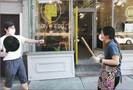  ?? Provided photo ?? Son of Egg owner Min Cho Ko, right, and her son Justin joke around in front of the family’s new Albany restaurant.