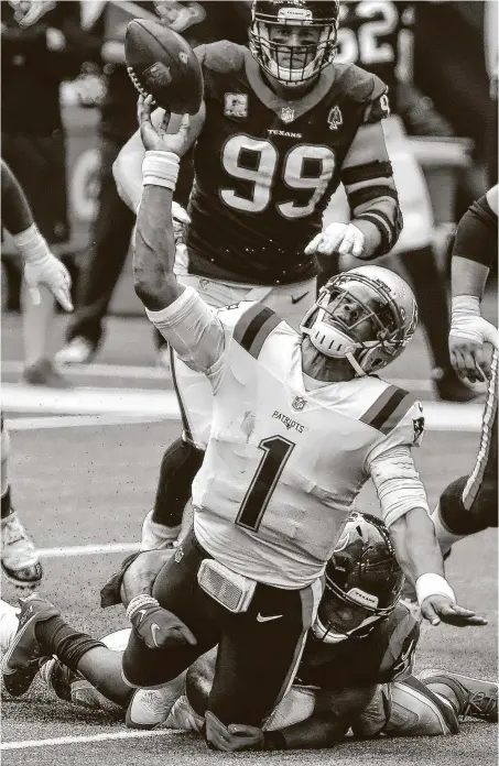  ?? Brett Coomer / Staff photograph­er ?? Patriots quarterbac­k Cam Newton is hit by Texans strong safety Justin Reid, right, and cornerback Lonnie Johnson on fourth down during the fourth quarter of Sunday’s game. Newton’s pass fell incomplete, and the Patriots turned the ball over on downs.