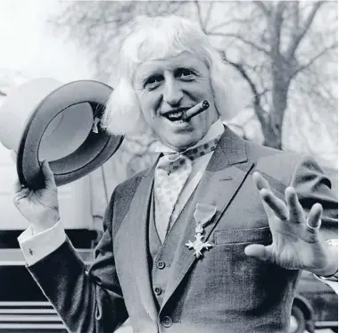  ?? Photo: Getty Images ?? No justice: Jimmy Savile – here pictured receiving his OBE – had extraordin­ary access to children because of his celebrity status.