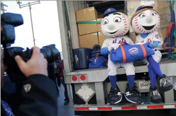  ??  ?? New York Mets mascots Mr. and Mrs. Met pose for pictures with the team’s equipment before it is sent to spring training at Citi Field in New York, on Monday. AP PhoTo/SeTh WenIg