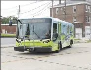  ?? (NWA Democrat-Gazette/Spencer Tirey) ?? An Ozark Regional Transit bus leaves a stop Friday in downtown Rogers. Go to nwaonline.com/200713Dail­y/ and nwadg. com/photos for a photo gallery.