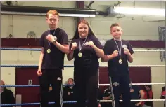  ??  ?? Chris Wall, Bridget Cash and Cole Byrne with their gold medals.