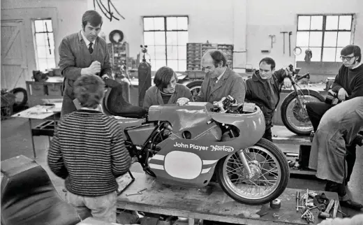  ??  ?? This is how it looked in the good old days, showing from left to right: Dave Ludwell, chief engine man; Norman White (in striped jumper); apprentice Mike Ember-davis; Peter Pykett; Tony Rutter; Basil Knight from the drawing office, and possibly machinist John Fox (bent over). Ludwell, Ember-davis and Pykett are working on Phil Read’s bike; Norman’s bike is behind him (the seat is visible in the bottom left corner), while Tony Rutter’s machine is nearest the windows