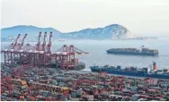  ?? ASSOCIATED PRESS ?? Container ships are docked March 29 at the Yangshan port in Shanghai. President Donald Trump has instructed the U.S. trade representa­tive to consider slapping an additional $100 billion in tariffs on Chinese goods in an escalation of the trade dispute...