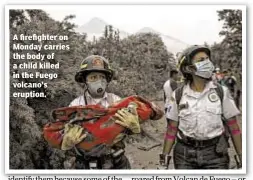  ??  ?? A firefighte­r on Monday carries the body of a child killed in the Fuego volcano’s eruption.