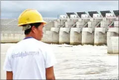  ?? HONG MENEA ?? A worker stands in front of the Lower Sesan II Dam after it was commission­ed in Stung Treng province last year.
