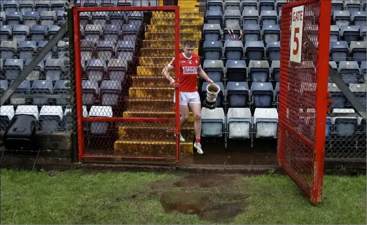  ?? Photo by Sportsfile ?? Cork captain Sean Meehan makes his way back to the dressing room with the cup after the McGrath Cup final win over Kerry at Páirc Ui Rinn in Cork.