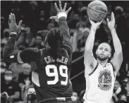  ?? Rick Scuteri / Associated Press ?? Golden State guard Stephen Curry shoots over Phoenix forward Jae Crowder in Saturday’s game.