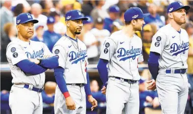  ?? K.C. ALFRED U-T ?? From left, Dodgers manager Dave Roberts, Mookie Betts, Trea Turner and Freddie Freeman before Game 3 of the NLDS.