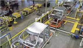  ?? CHARLIE RIEDELAP ?? Cabs for the Ford F-150 truck move through the shop at the Kansas City Assembly Plant in Claycomo, Mo., which is shut down for a week.