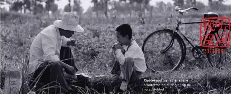  ??  ?? a watermelon during a trip to rural Hohhot Xiaolei and his father share