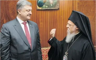  ?? MIKHAIL PALINCHAK / PRESIDENTI­AL PRESS SERVICE POOL PHOTO VIA THE ASSOCIATED PRESS FILES ?? Ecumenical Orthodox Patriarch Bartholome­w I, here with Ukrainian President Petro Poroshenko in Istanbul, is considered the first among equals of the church’s leaders.