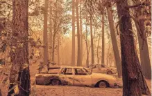  ?? NOAH BERGER/AP ?? Cars sit in the Indian Falls community of Plumas County, Calif., on Sunday, scorched by a wildfire.