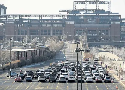  ?? Helen H. Richardson, The Denver Post ?? Drivers are directed out of one parking lot to another where they will wait for 15 minutes before leaving after getting COVID-19 vaccinatio­ns at a UCHealth drive-up event Sunday in the parking lots of Coors Field.