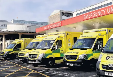  ??  ?? > Ambulances queuing outside A&E at the University Hospital of Wales Cardiff last month