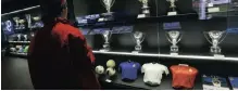 ??  ?? A man looks at Real Madrid’s trophies displayed at their museum at the Santiago Bernabeu stadium in Madrid.