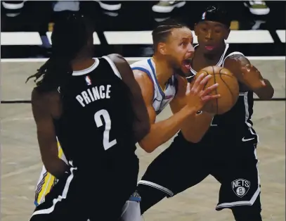  ?? PHOTOS BY KATHY WILLENS — THE ASSOCIATED PRESS ?? Nets forward Taurean Prince (2) and guard Caris LeVert (22) defend Warriors guard Stephen Curry as Curry looks to shoot during the first quarter on Tuesday in New York.