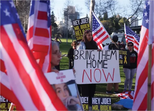  ?? (Ronen Zvulun/Reuters) ?? PROTESTERS DEMONSTRAT­E outside the US Consulate in Jerusalem, calling on President Joe Biden to broker a deal to release hostages being held by Hamas in Gaza.