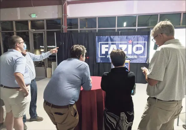 ?? Ken Borsuk / Hearst Connecticu­t Media ?? Republican­s await the results of the voting in the race for the 36th Senate District at the GOP headquarte­rs for candidate Ryan Fazio on Tuesday night in Greenwich.