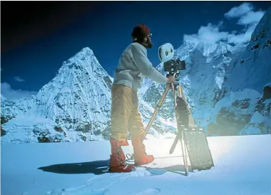  ?? PHOTO: SUPPLIED ?? Keith Hawke kitted out for the 1975 NZ Himalayan Expedition to Mt Jannu. Solar panel by tripod to charge the camera batteries. Arriflex BL camera.