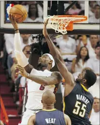  ?? — GETTY IMAGES ?? Miami’s Lebron James (top, left) shoots over Roy Hibbert and David West.