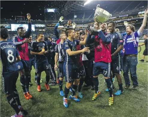  ?? — AP FILES ?? Whitecaps players celebrate after defeating the Seattle Sounders on Oct. 10, 2014. The Whitecaps won the Cascadia Cup that year after beating the Sounders 1-0 and could win it again Sunday with a win over Portland.