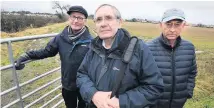  ??  ?? Hands off Campaigner­s Dougie Graham, Dave Chambers and Bill Lockie at the ‘sacrosant’ land which now seems safe