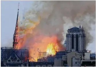  ?? THIBAULT CAMUS / ASSOCIATED PRESS ?? Notre Dame cathedral, the iconic symbol of the beauty and history of Paris, was devastated by a catastroph­ic fire Monday evening that bruised the Parisian skies with smoke and further dishearten­ed a city already back on its heels after weeks of violent protests.