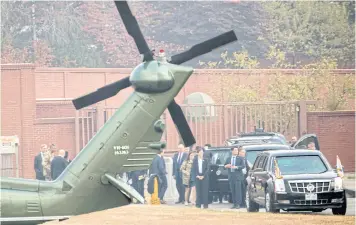 ??  ?? CLOSE CALL: President Trump sits in his limo as members of the administra­tion wait out bad weather at US Army Garrison Yongsan, Seoul, South Korea, Nov 8, 2017. Marine One turned back because of a bad weather call just minutes away from visiting the DMZ.