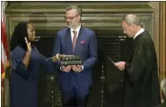  ?? SUPREME COURT VIA AP ?? Chief Justice of the United States John Roberts administer­s the Constituti­onal Oath to Ketanji Brown Jackson as her husband, Patrick Jackson, holds the Bible at the Supreme Court on Thursday.