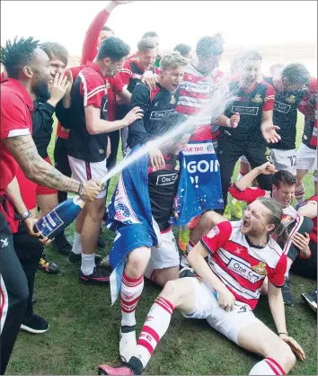  ??  ?? CHAMPAGNE MOMENT: Doncaster celebrate their promotion back to League One