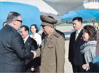  ?? MATTHEW LEE THE ASSOCIATED PRESS ?? U.S. Secretary of State Mike Pompeo greets an unidentifi­ed North Korean general on arrival in North Korea on Wednesday. He’s flying home with three detained Americans.