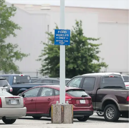  ?? JASON KRYK ?? A sign restrictin­g non-Ford vehicle parking is posted at the automaker’s engine plant on Henry Ford Centre Drive on Monday. The policy was originally slated to come into effect on July 1 but has been rescinded.