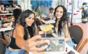  ?? MATIAS J. OCNER mocner@miamiheral­d.com ?? Tracy, left, and her friend, Jessica Gooden, from New York, take a selfie while visiting Miami Beach.