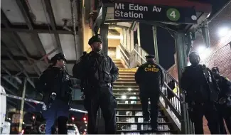  ?? ?? New York City Police officers stand guard following a shooting at the Mount Eden subway station, Monday, Feb. 12, 2024, in the Bronx borough of New York.