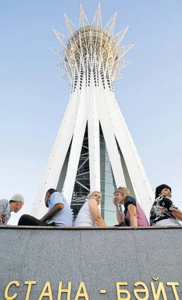  ?? Picture: REUTERS ?? JAGSHEMASH: People rest under the Bayterek Tower, a popular tourist attraction in Astana