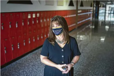  ?? Jon Shapley / Staff photograph­er ?? Lynette Miller, principal of Hastings High School, described a sense of sadness over the school’s empty hallways.